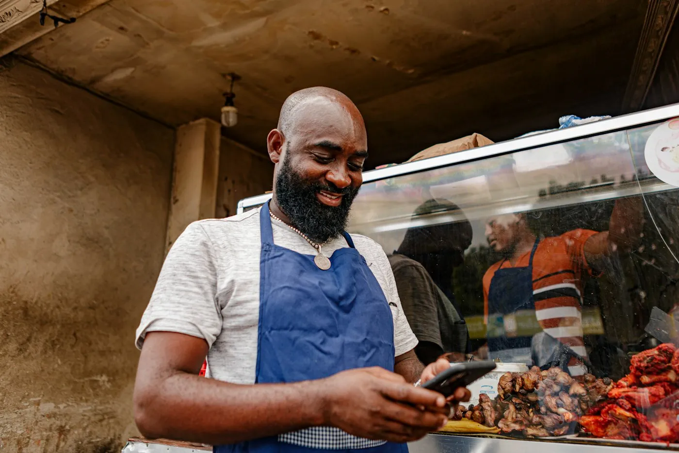 A business owner checking an app on their phone at work.