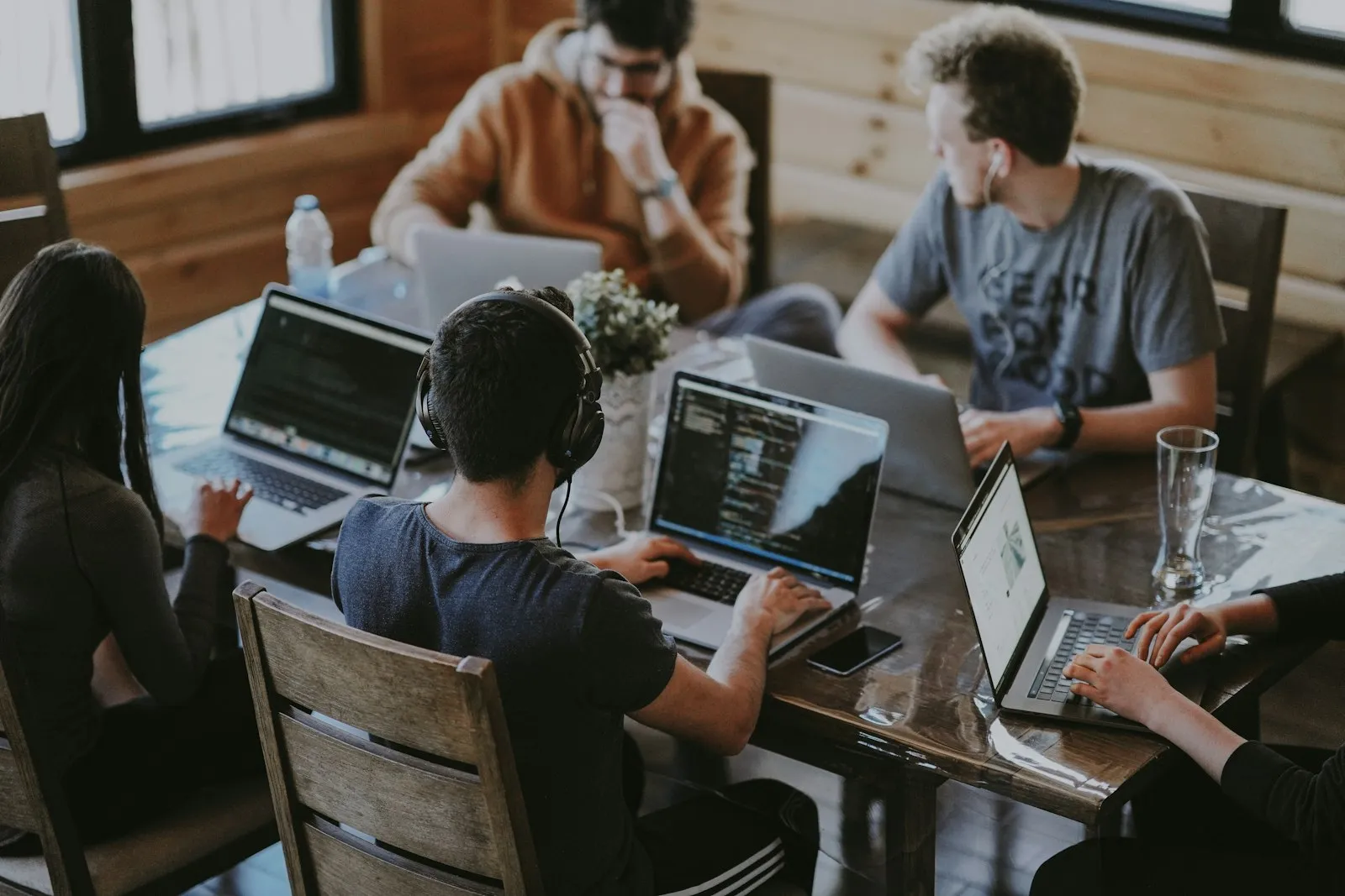 A small team reviewing a web product on a laptop together.